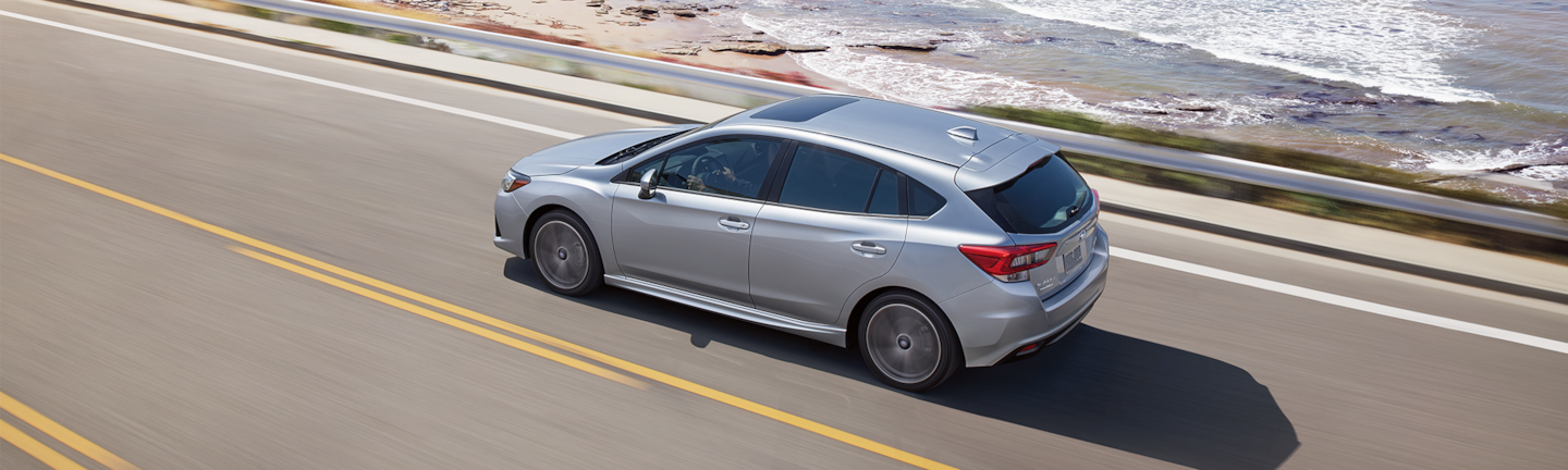 A 2023 Impreza driving on the coast.