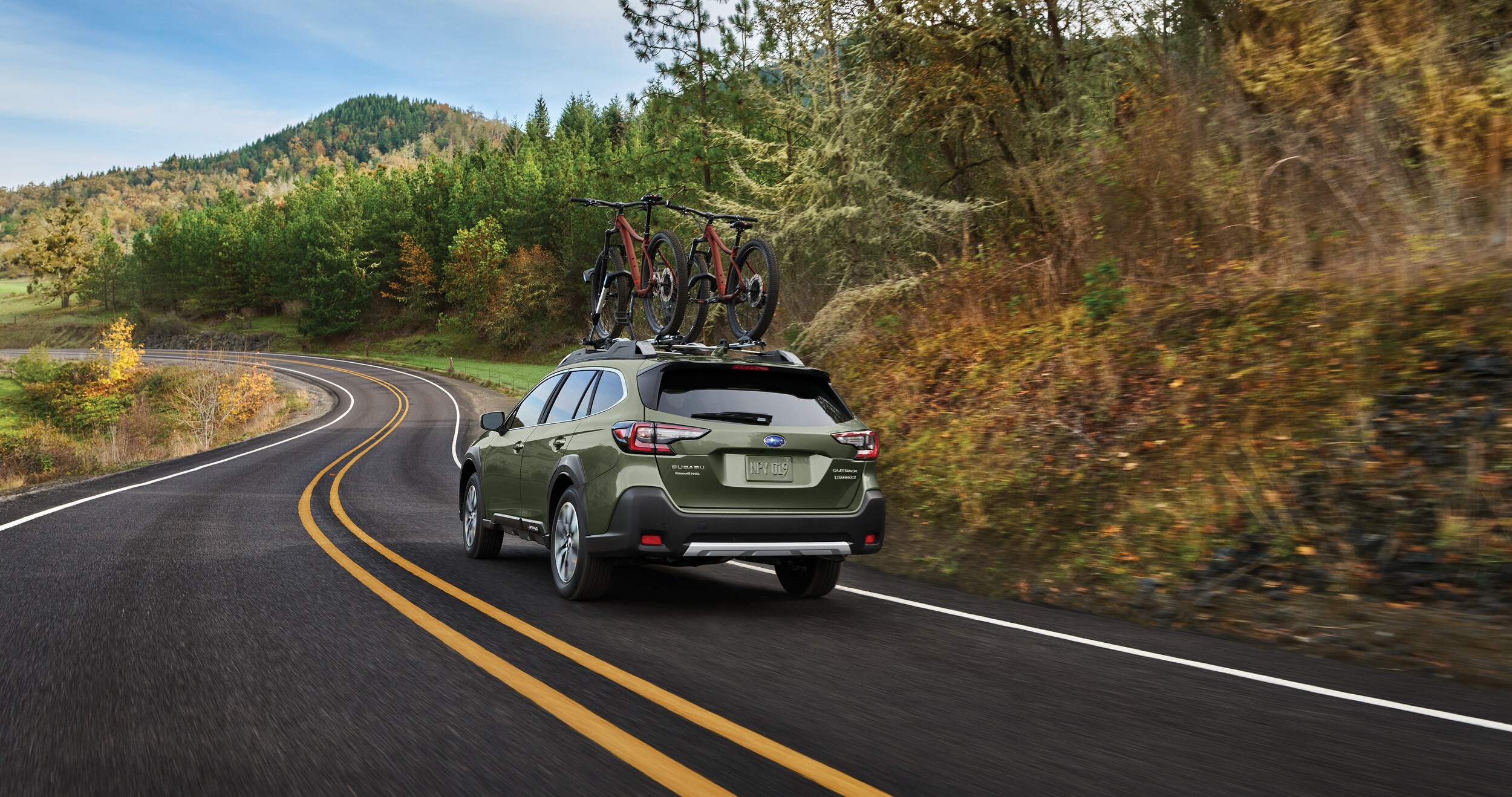 A 2023 Outback driving through the countryside.