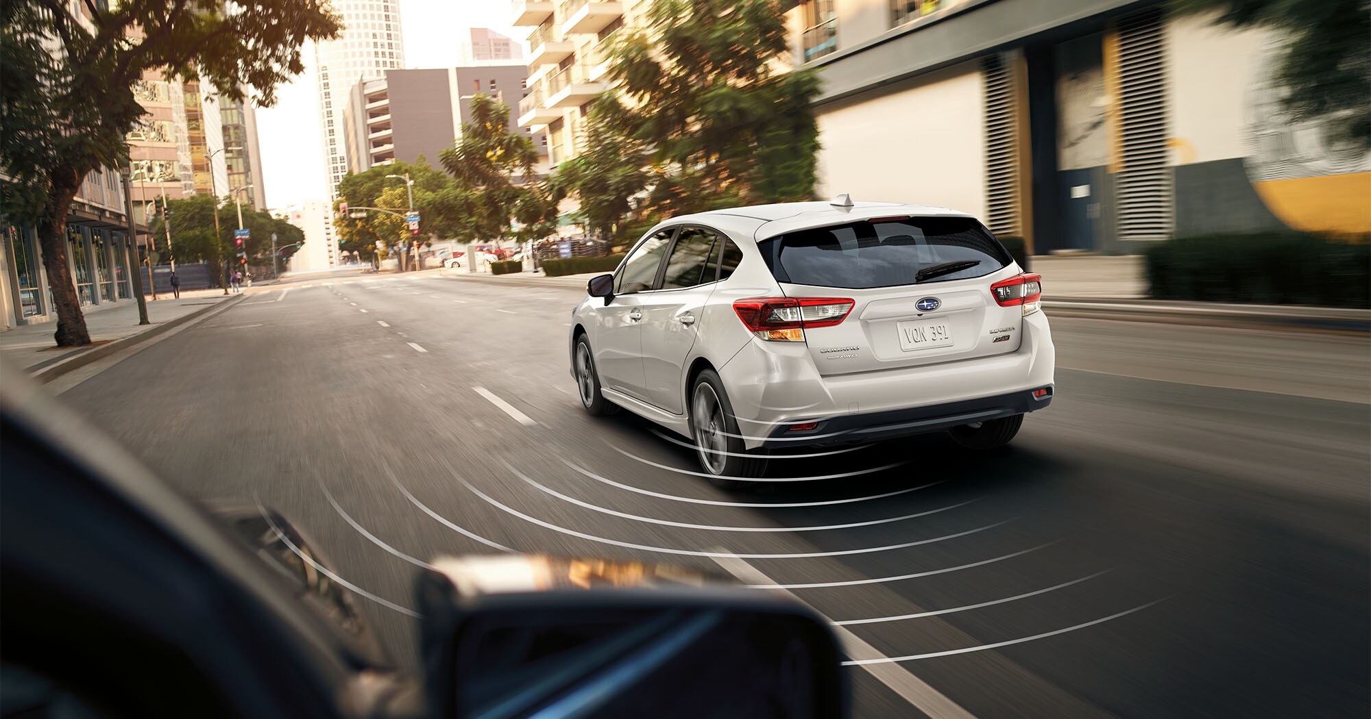  A photo illustration showing the Blind-Spot Detection feature available on the 2023 Impreza hatchback.