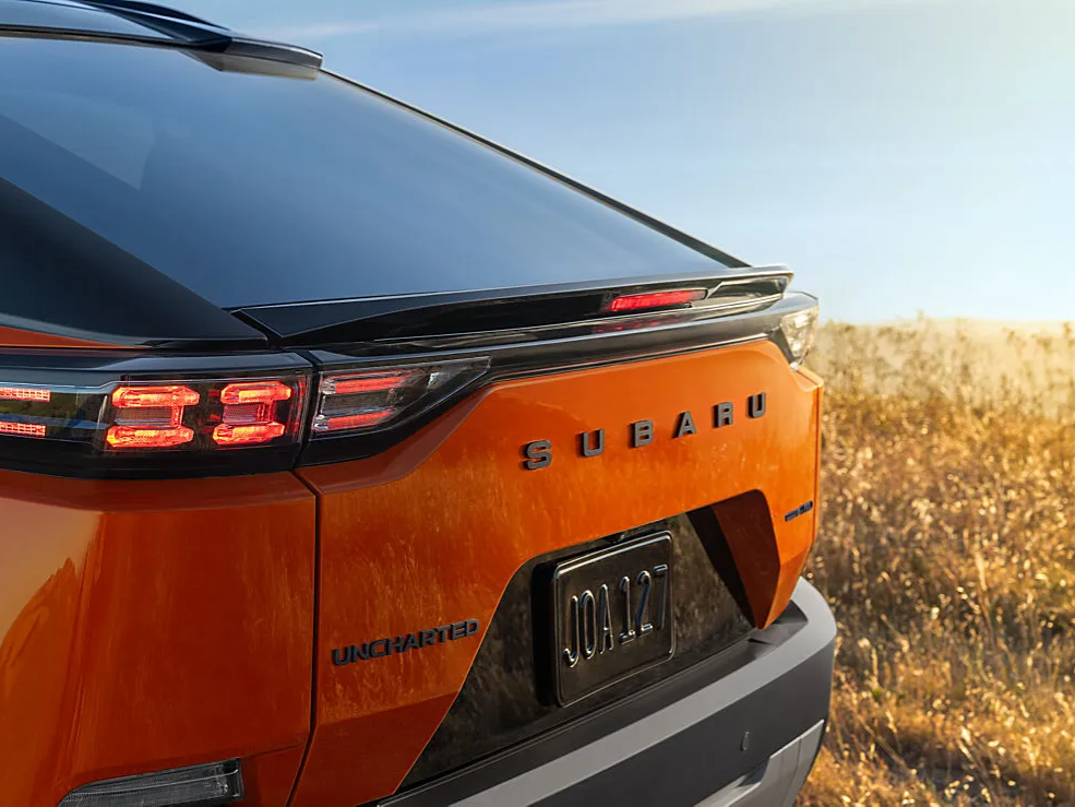A Subaru Uncharted SUV parked next to a wheat field.