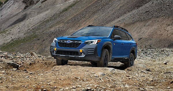 A 2023 Outback Wilderness driving on a trail in the mountains.
