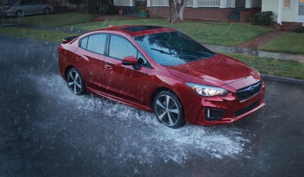 Subaru Impreza driving through the rain