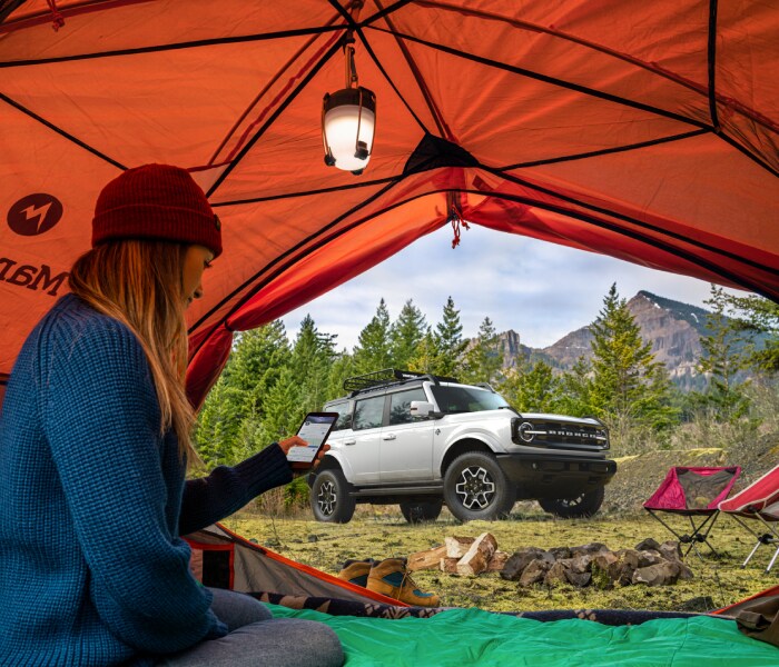 Ford Bronco with people camping