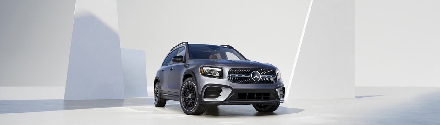 Grey Mercedes-Benz GLB with an AMG package parked in a white space