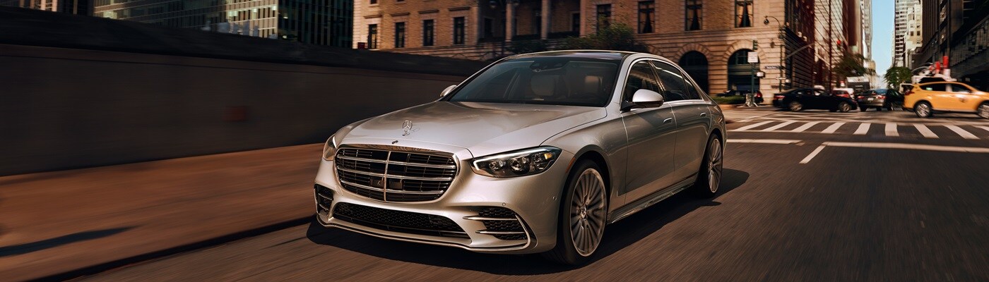 White Mercedes-Benz S-Class driving in a city