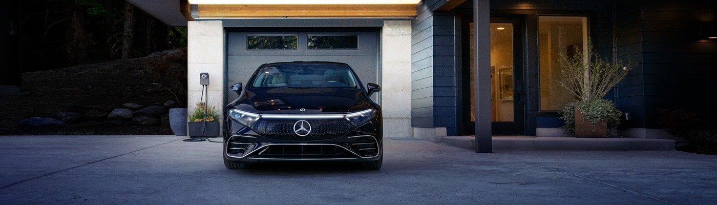 EQS Sedan Black EQS Sedan charging in front of a garage