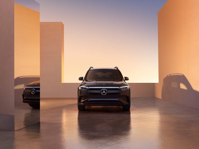 Blue Mercedes-Benz EQB SUV parked near amber structures