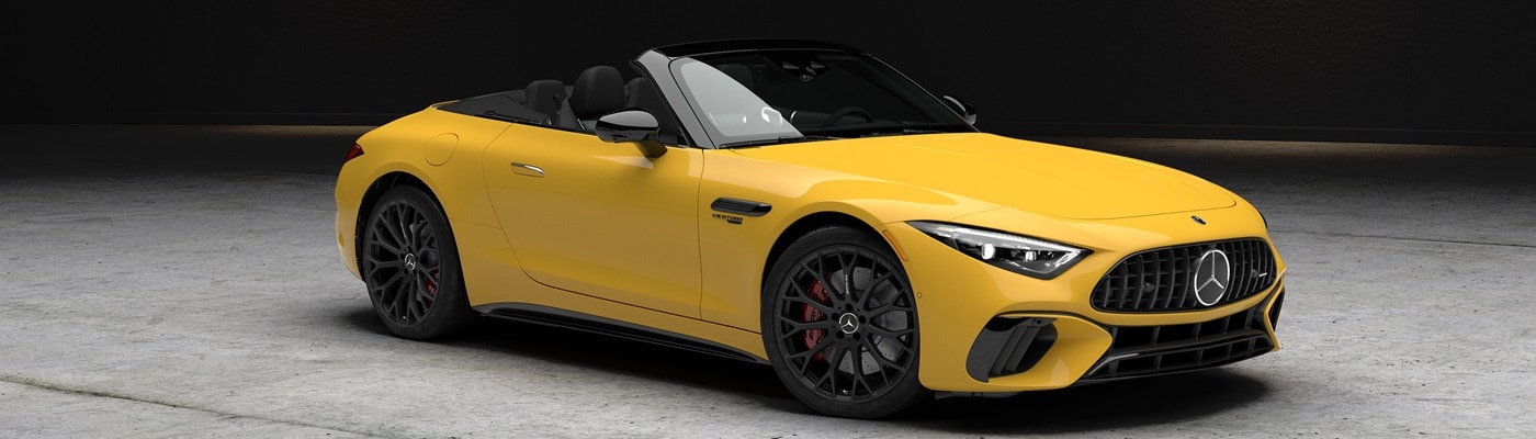 Yellow Mercedes-Benz AMG SL 63 parked in a warehouse under a spotlight