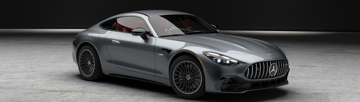 Grey Mercedes-Benz AMG GT Coupe parked in a warehouse under a spotlight