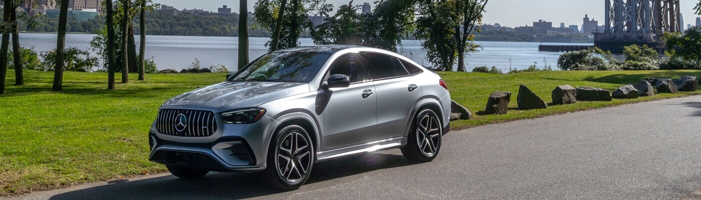 Silver AMG GLE parked by a riverfront