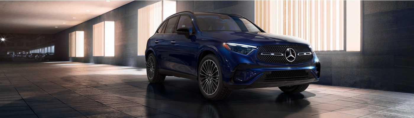 Mercedes-Benz GLC SUV parked in a city in front of glowing windows