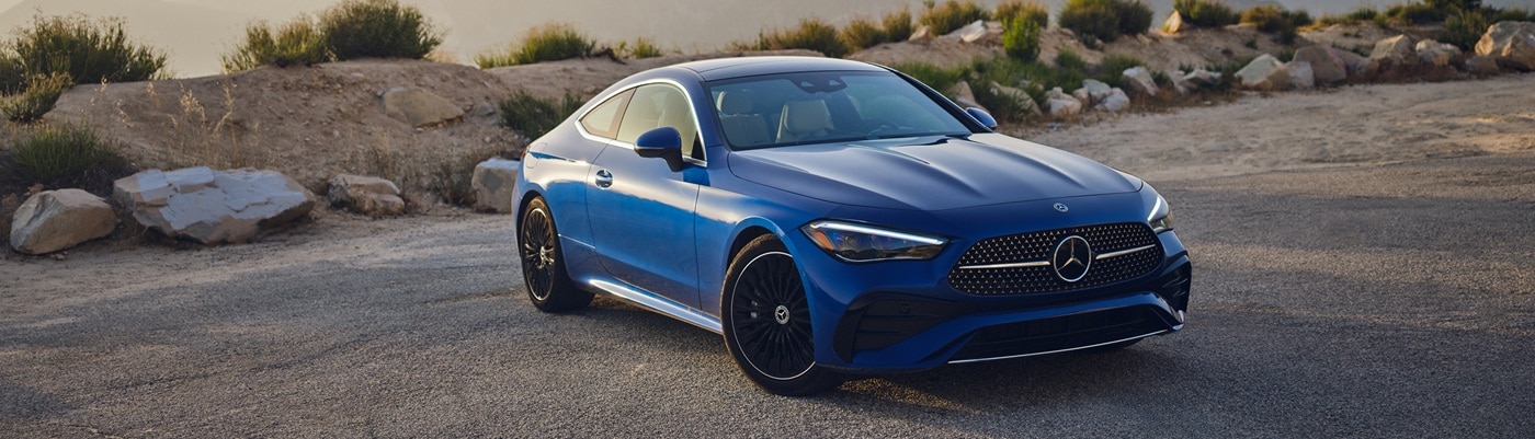Blue CLE Coupe parked in the desert