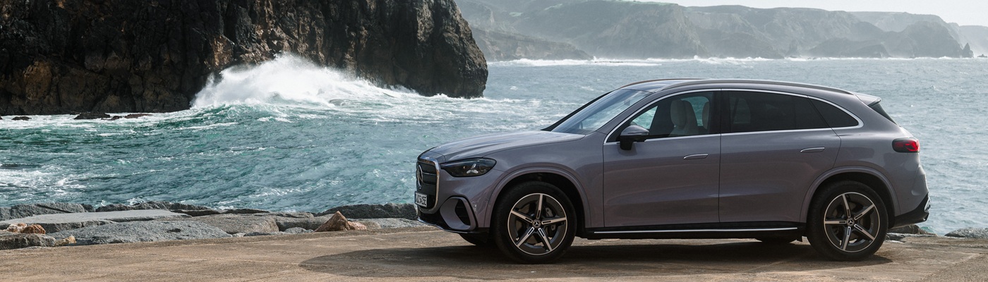 Grey Mercedes-Benz GLC Electric parked beside a ocean coast
