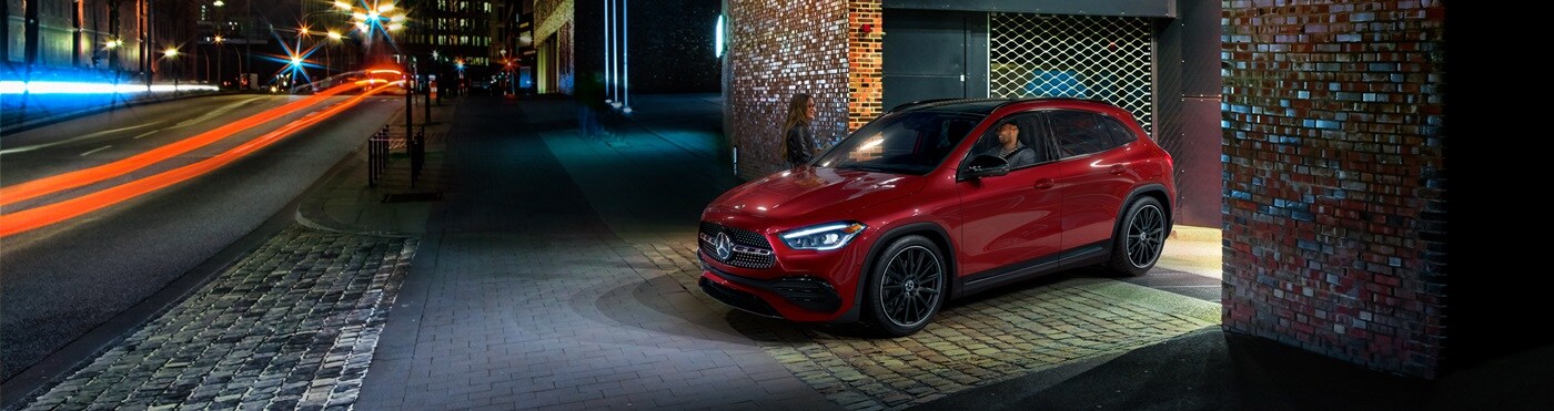 Red Mercedes-Benz GLA pulling out onto a street