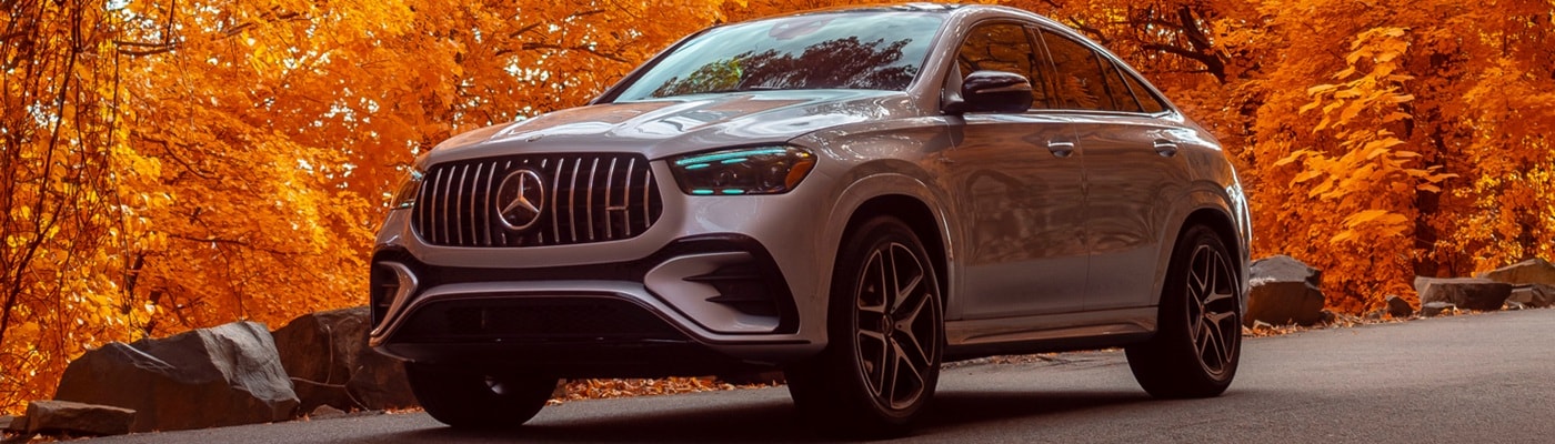 Mercedes-Benz AMG GLE Silver Mercedes-Benz AMG GLE Coupe driving thru a city park in the fall