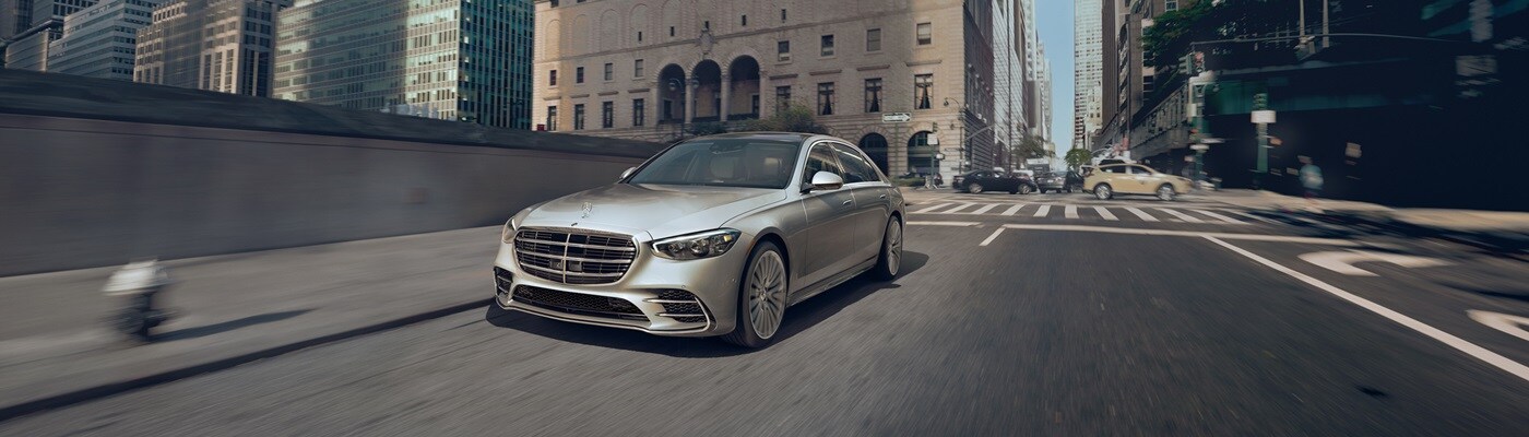 Mercedes-Benz S-Class White Mercedes-Benz S-Class driving in a city