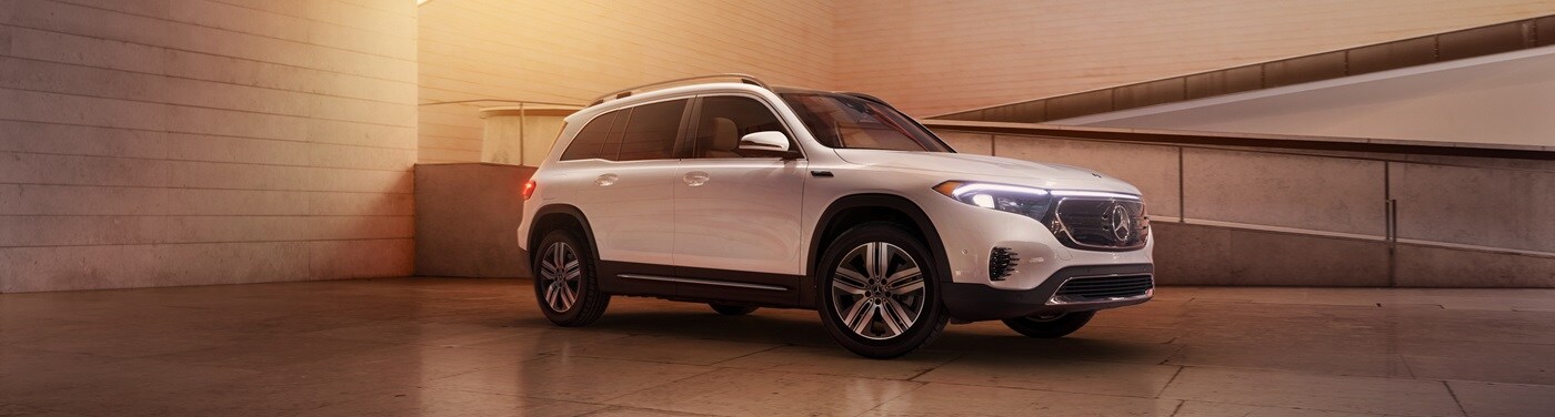 White EQB parked in amber light