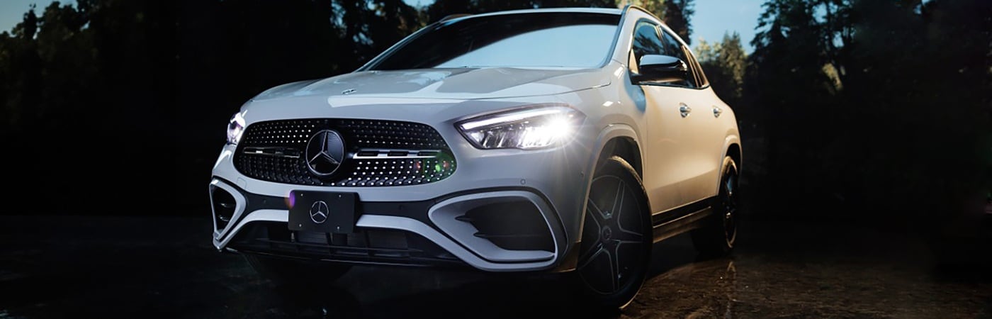 White Mercedes-Benz GLA SUV parked on a slick black stone surface