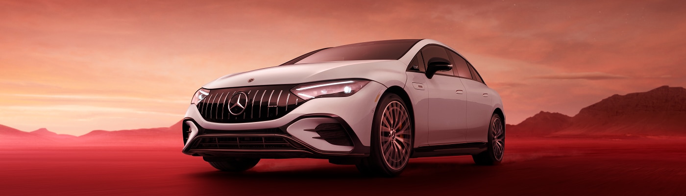 AMG EQE Sedan driving in a red desert