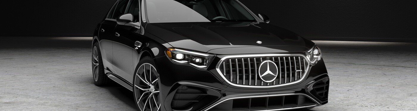 Black Mercedes-Benz AMG E 53 parked in a concrete warehouse