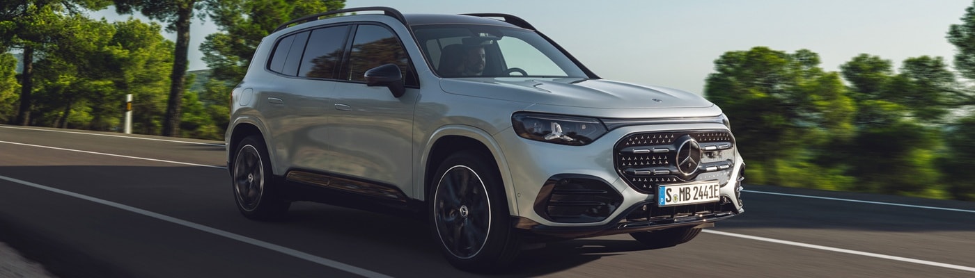 Mercedes-Benz AMG GLB 35 driving on a sunny road in the forest