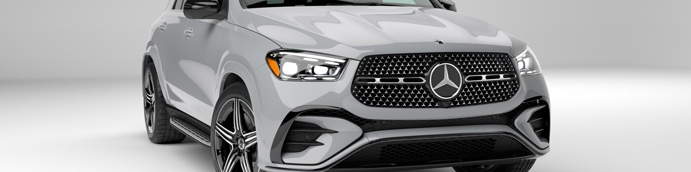 The grille of a Silver Mercedes-Benz GLE 580 parked in a white modern space
