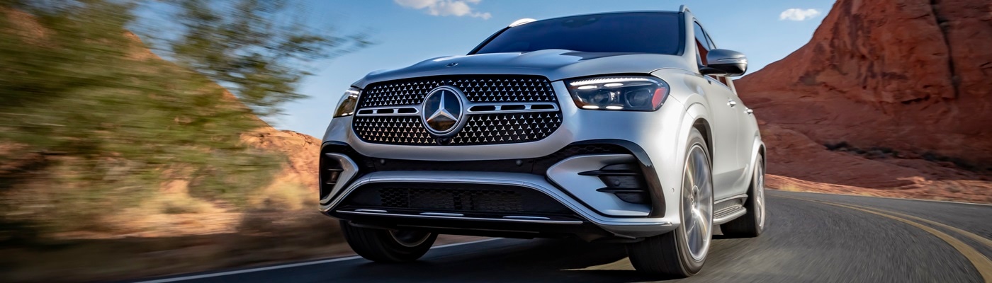Silver Mercedes-Benz GLE 450 driving on a road in the desert