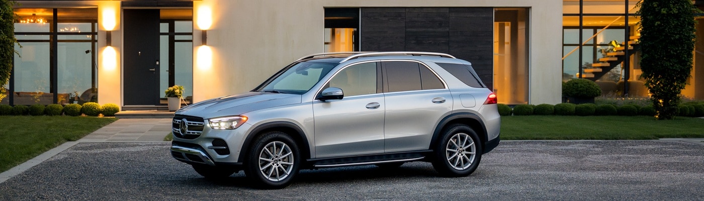 Silver Mercedes-Benz GLE 450 parked in front of a modern home
