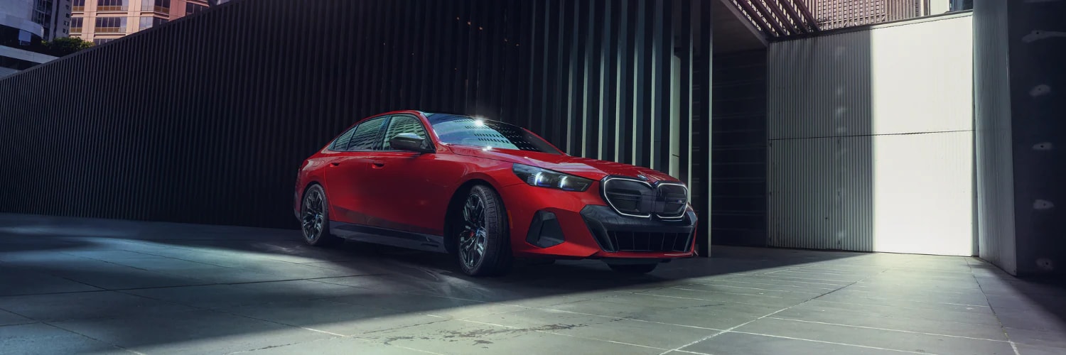 red BMW 5 Series on city streets
