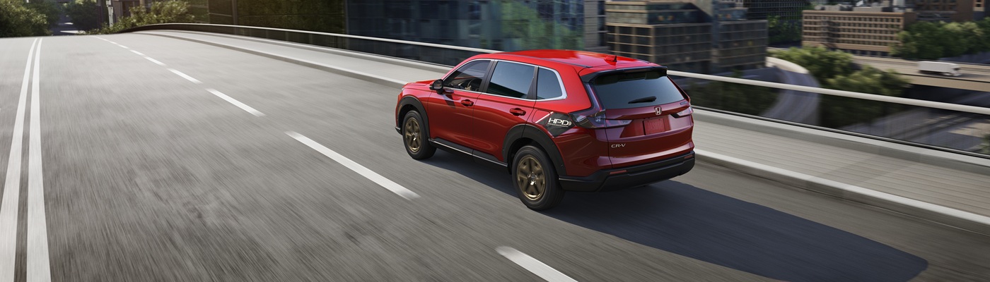 Honda CR-V Red Honda CR-V driving on a city street
