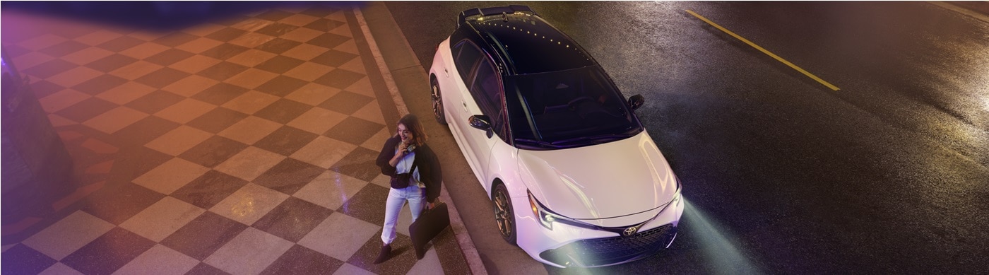 White Toyota Corolla Hatchback Nightshade parked on a street at night