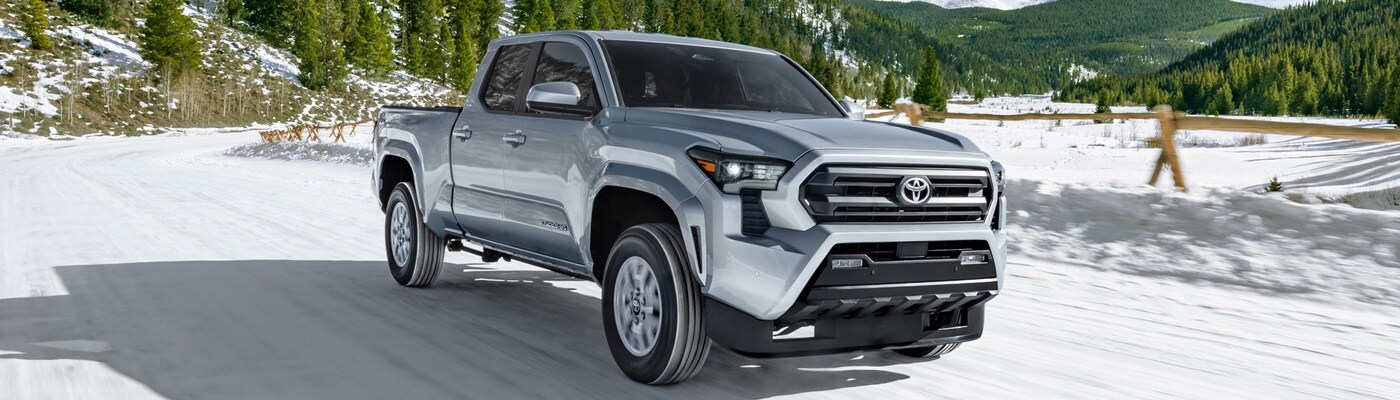 Grey Toyota Tacoma SR5 Truck driving on a snowy road