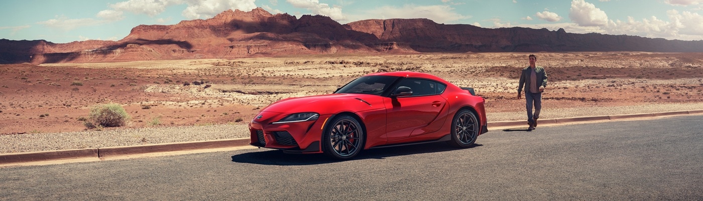Red Toyota GR Supra parked in the desert