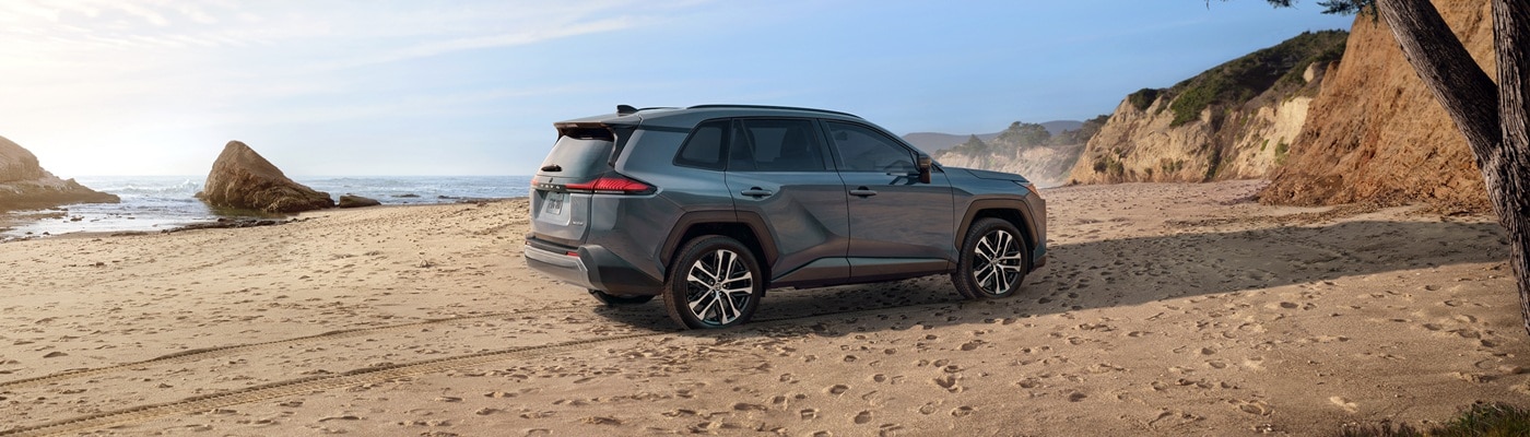 Blue Toyota RAV4 Limited parked on a beach