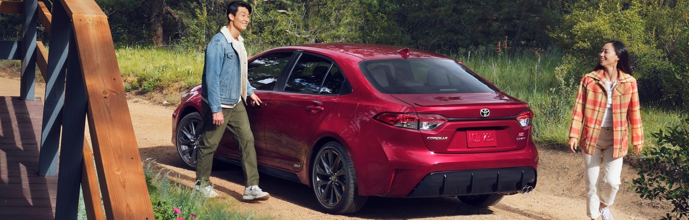 Red Toyota Corolla SE parked by a vacation house