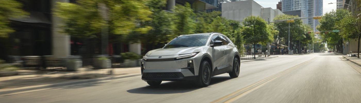 2026 Toyota C-HR with Wind Chill Pearl Paint driving in the city