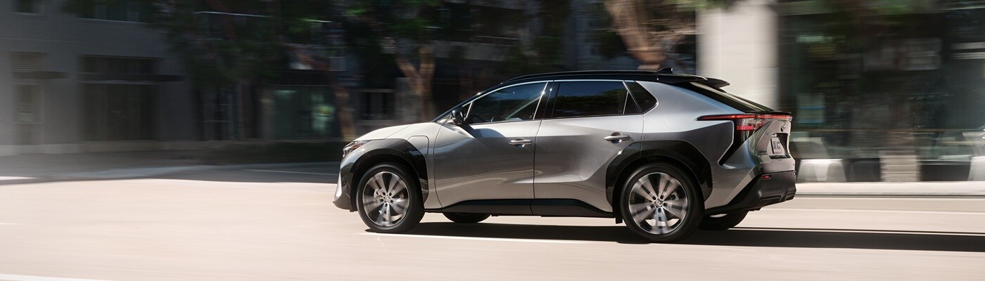 Grey Toyota bZ4X Limited driving in a city