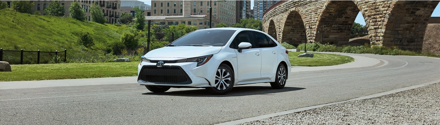White Toyota Corolla Hybrid parked in a city