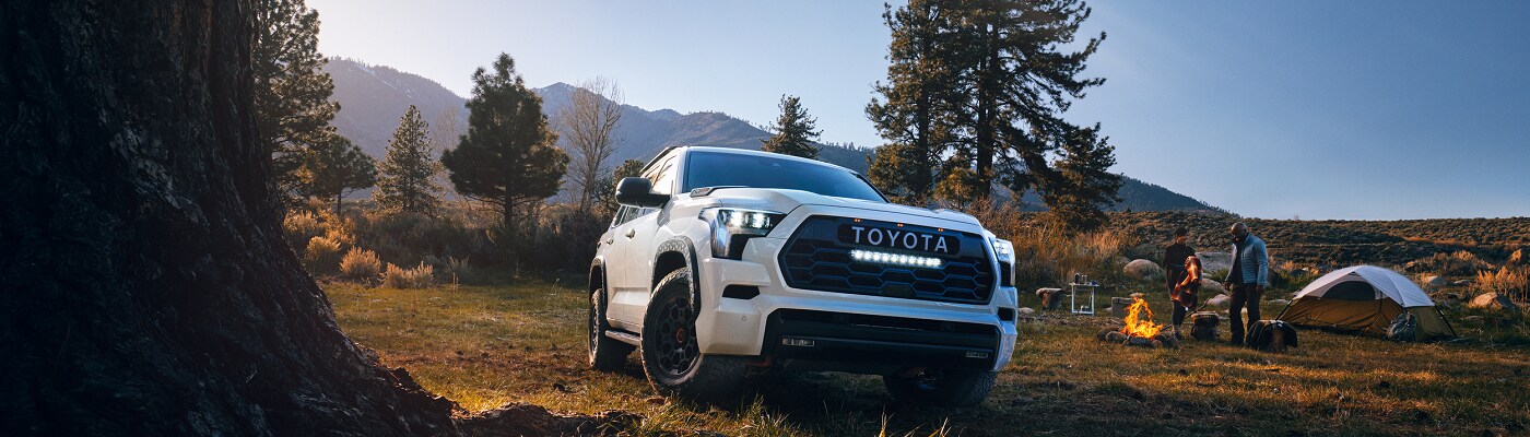 White Toyota Sequoia parked at a campsite