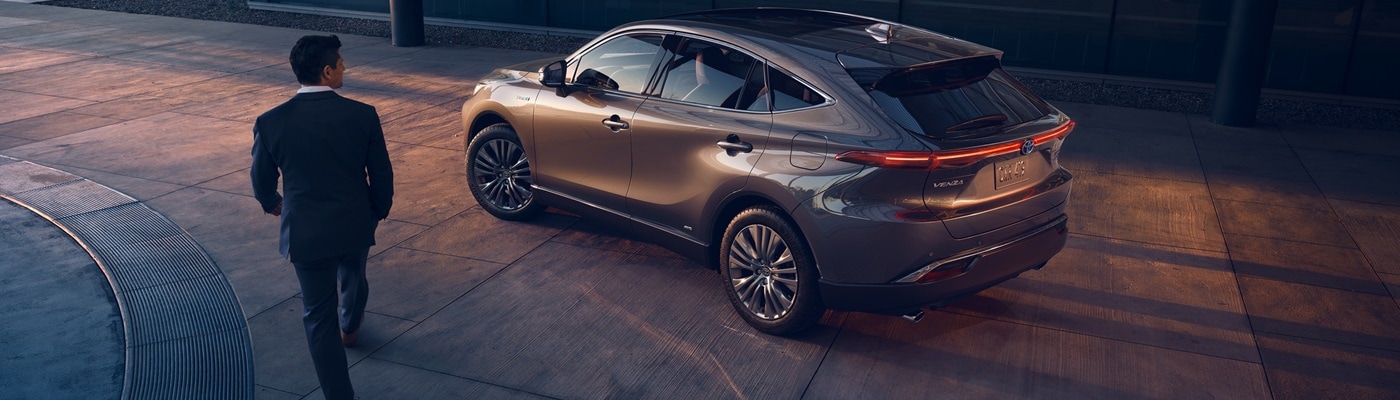 Grey Toyota Venza Limited parked near a modern building