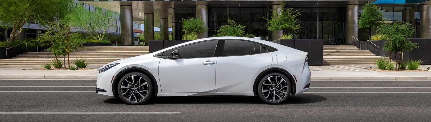 White Toyota Prius PHEV XSE Premium parked in front of an office building