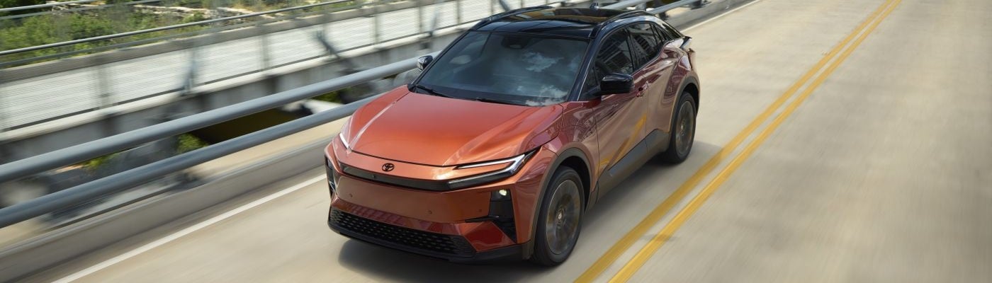 2026 Toyota C-HR with Tandoori paint and Midnight Black Metallic roof driving on the highway.jpg