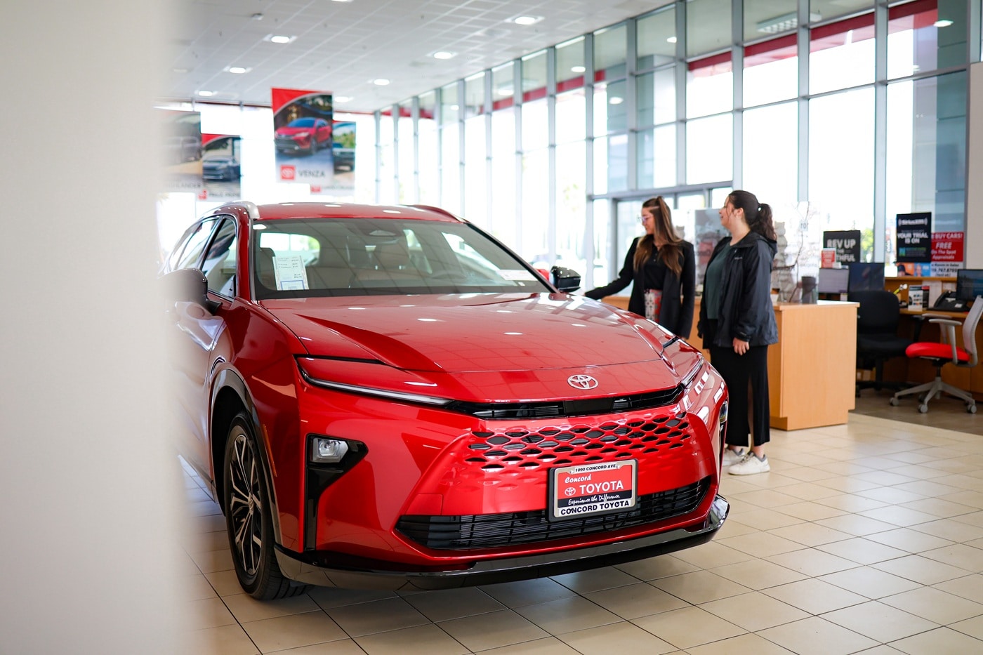 Concord Toyota Interior Showroom Interior of the Concord Toyota showroom with a team member showing a guest a new Toyota