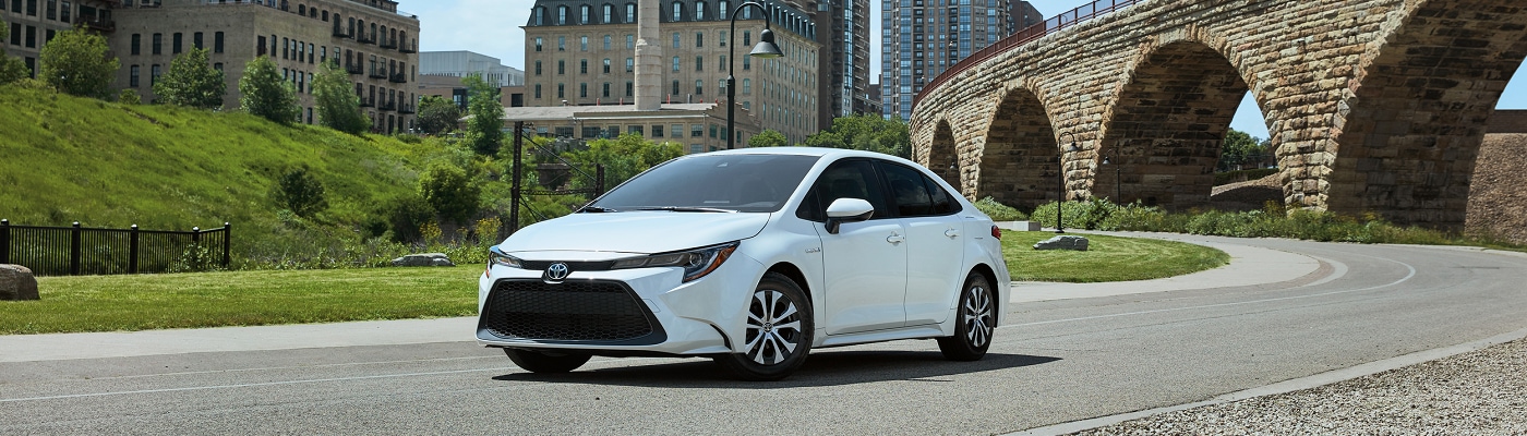 White Toyota Corolla Hybrid parked in a city