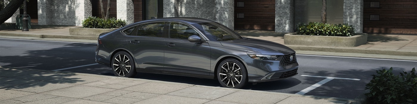 Grey Accord Touring Hybrid parked on a city street