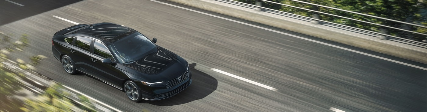 Black Accord Sport Hybrid driving on a highway