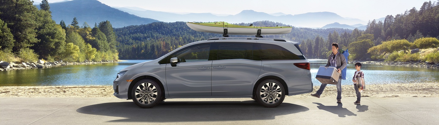 Honda Odyssey Silver Odyssey Elite parked beside a lake