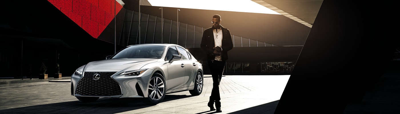 Grey Lexus IS parked near a modern building