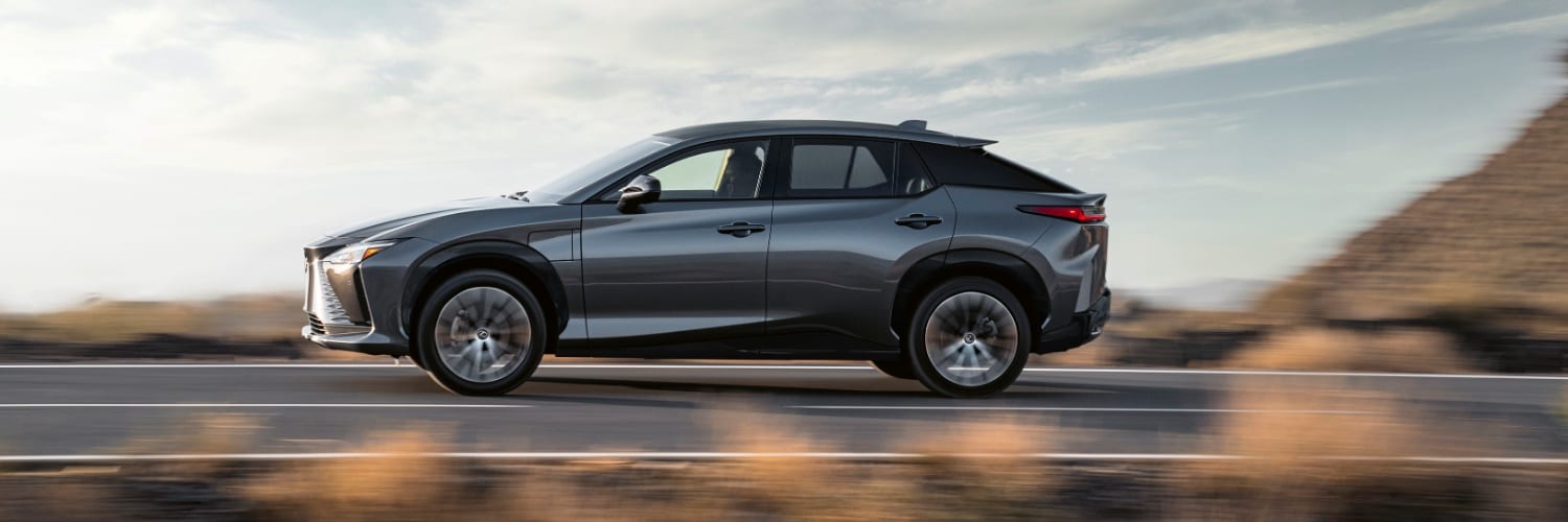Gray Lexus RZ 300e driving on a mountain highway