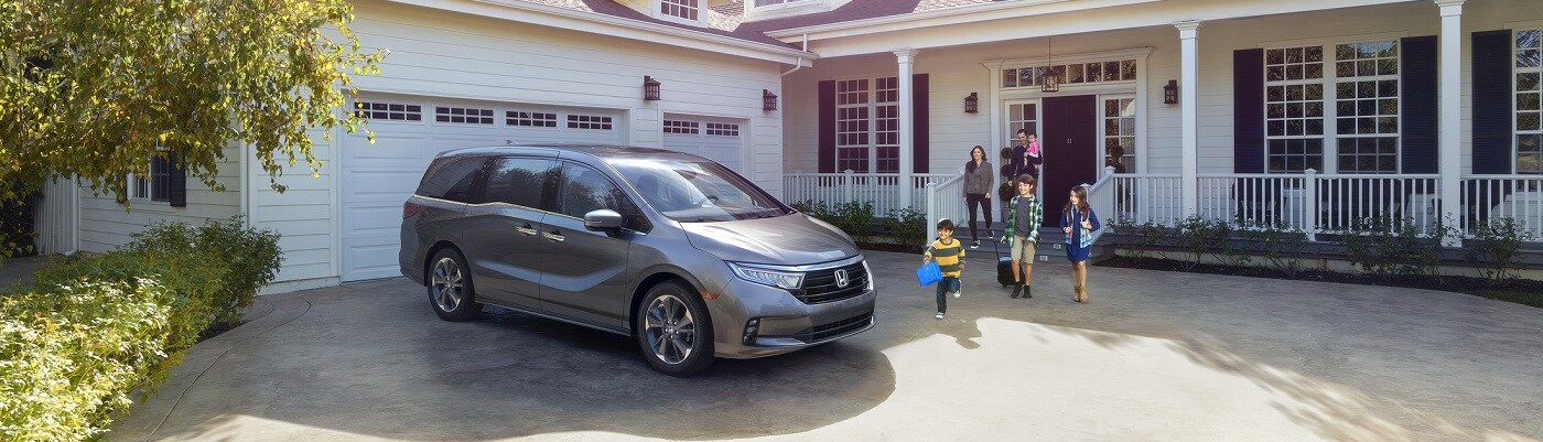 Honda Odyssey Elite Grey Honda Odyssey Elite parked by a large house